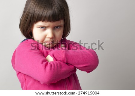 unhappy boyish 4-year old girl expressing disagreement with body language Royalty-Free Stock Photo #274915004