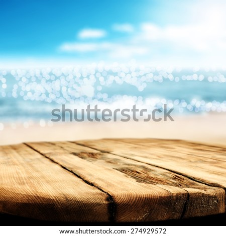 tropical background of ocean and worn table desk top 