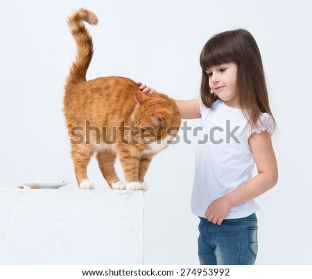 Cute little girl portrait hug red cat smiling 