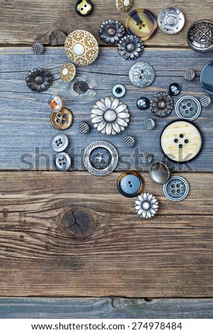 Several vintage buttons on old wooden table