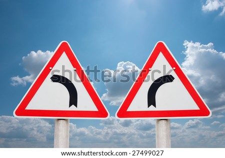 Turning road traffic signs showing opposite directions