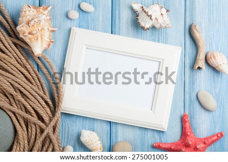 Summer time sea vacation with blank photo frame, star fish and marine rope 