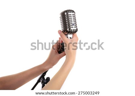 Retro microphone in female hands isolated on white