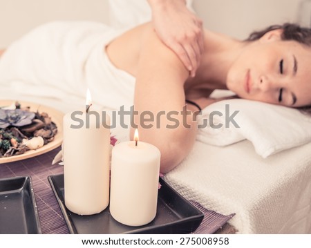 woman making massage in a beauty saloon. concept about spa, relaxation, body care and people Royalty-Free Stock Photo #275008958