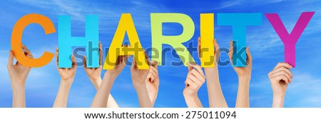 Many Caucasian People And Hands Holding Colorful Straight Letters Or Characters Building The English Word Charity On Blue Sky