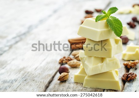 white chocolate on a white wood background. the toning. selective focus Royalty-Free Stock Photo #275042618