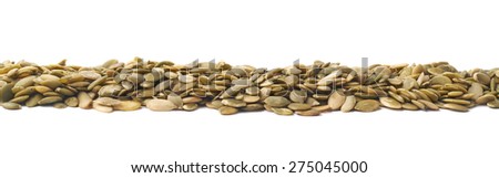 Border line made of pumpkin seeds isolated over the white background
