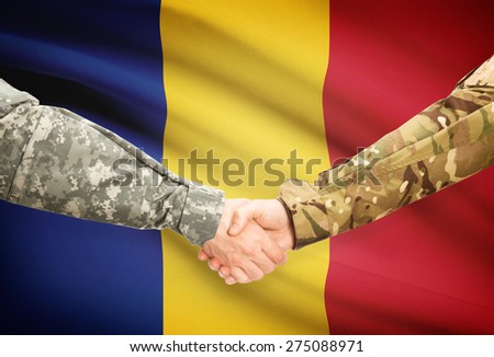 Soldiers shaking hands with flag on background - Romania