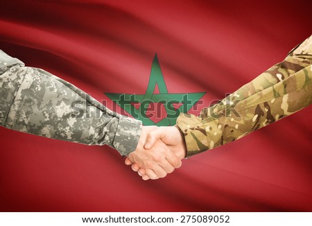 Soldiers shaking hands with flag on background - Morocco