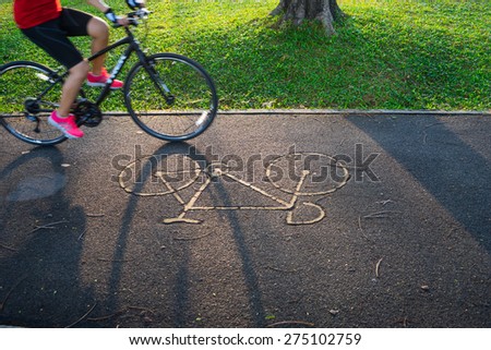 Bicycle sign or icon and movement of cyclist in the park