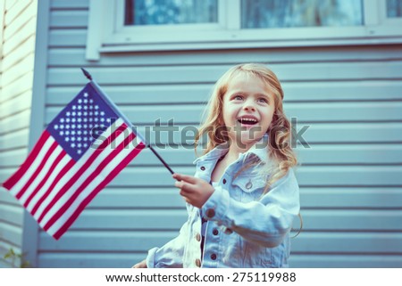Pretty little girl with long curly blond hair smiling and waving american flag. Independence Day, Flag Day concept. Vintage and retro toning. Instagram filters