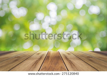 Fresh spring green with bokeh and sunlight and wood floor