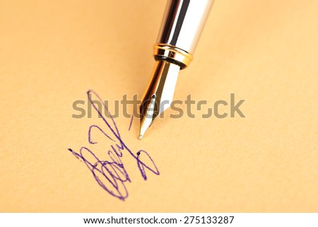 Pen and signature on paper background