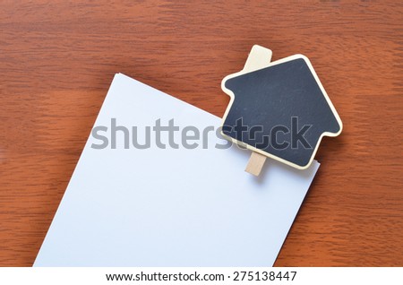 Empty sign clip over the white blank paper