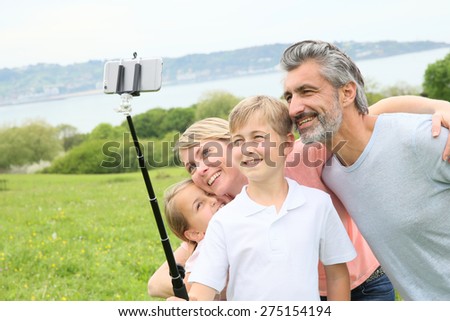Family in vacation taking selfie picture with smartphone