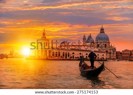Venetian gondolier punting gondola through green canal waters of Venice Italy Royalty-Free Stock Photo #275174153