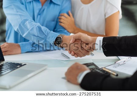 Close-up image of real estate agent and his client shaking hands Royalty-Free Stock Photo #275207531
