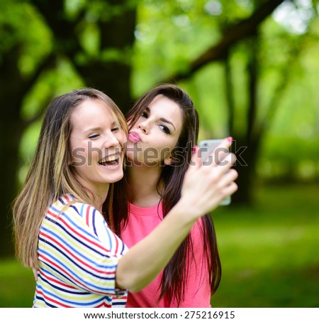 Friends making selfie on beautiful summer day in park