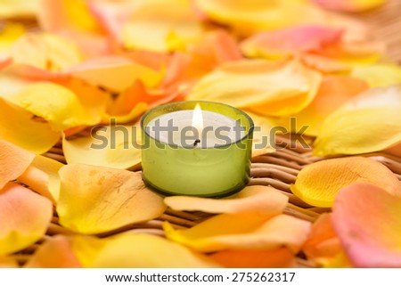 roses petals with,candle on bamboo mat