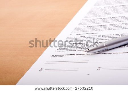 detail of a generic contract with a pen to sign (selective focus) Note: fictitious contract