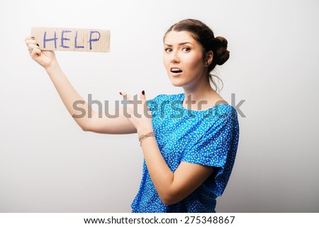 girl holding a sign help