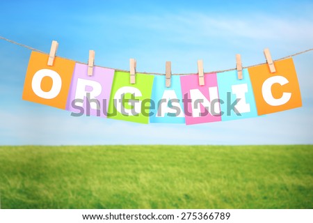 Organic spelled out in bright colored cards pegged to a line 