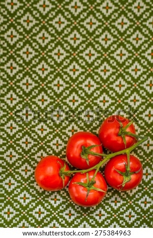 Tomatoes on a green vintage tablecloth