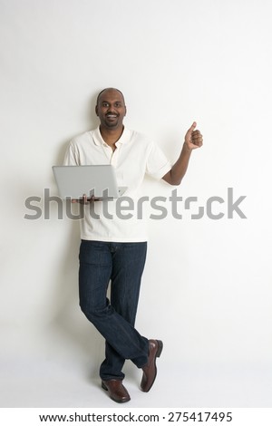 happy casual indian male with a laptop and thumbs up