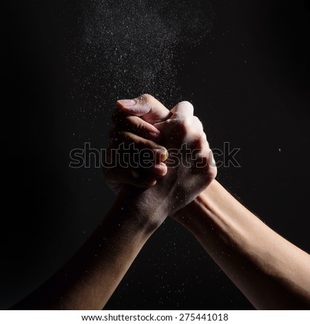 arm-wrestle of two man on black background