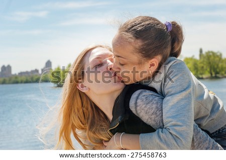 Daughter kissing mother 