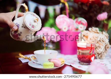 sweet table with flowers and a beautiful colorful and serving sweets to love story and photo shoot