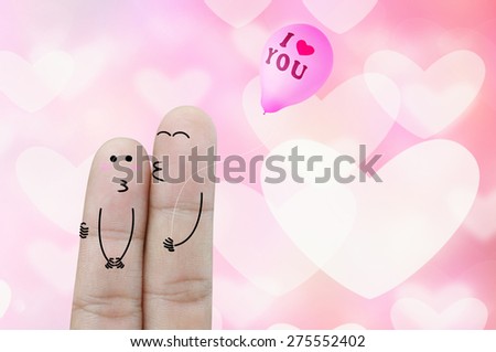 Fingers holding balloon on heart  bokeh  abstract background
