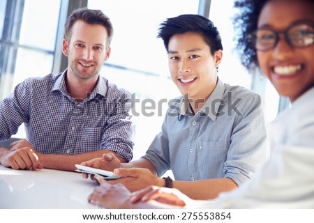 Three business professionals working together Royalty-Free Stock Photo #275553854