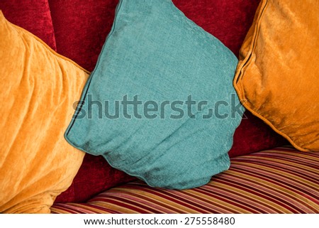 Colorful soft pillows on chair for comfortable seating