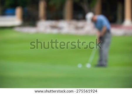 De focused or blurred man figure playing or driving golf on green background