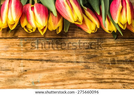 Tulips on a wooden background for mothers day, wedding invitation, greetings card and invitation cards, flowers background