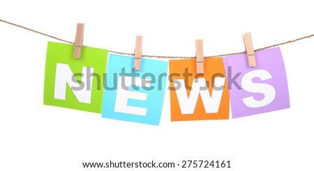 News Spelled out in cards pegged to clothesline on white background