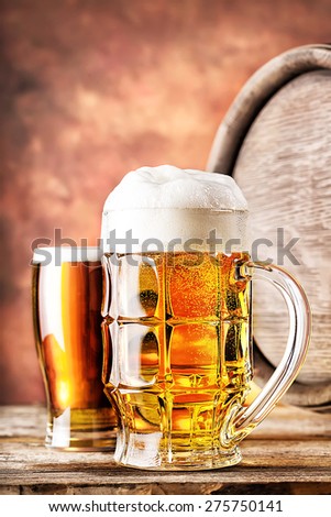 Mug and a glass of beer with a keg on red background