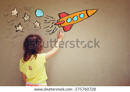 back view of cute kid (girl) imagine space rocket with set of infographics over textured wall background 