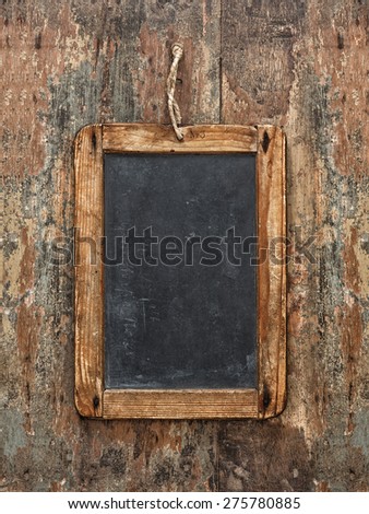 Antique chalkboard on wooden texture. Rustic background with copy space for your text. Vibrant colors, vintage style toned.