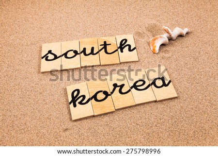 Words formed from small pieces of wood containing a sun and beach tourist destination, south korea