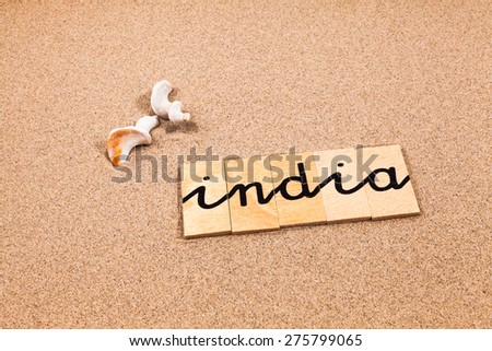 Words formed from small pieces of wood containing a sun and beach tourist destination, india
