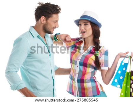 Attractive young couple holding shopping bags on white background