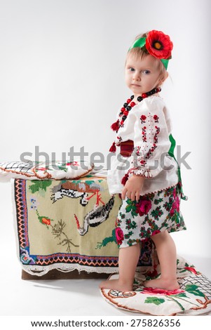 Beautiful Ukrainian little girl in the Ukrainian national native costume on Slavic holiday Ivan-Kupala.