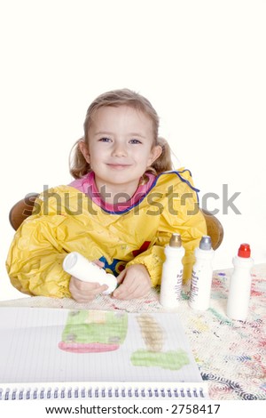 A little girl paints a picture isolated on a white background