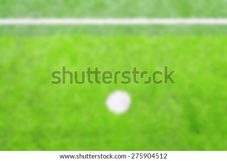 Photo of a green synthetic grass sports field with white line shot - Blurred picture style 