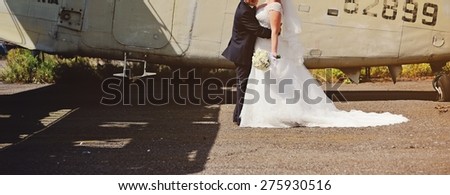 Happy bridal couple against old aircraft.  Wedding picture. 