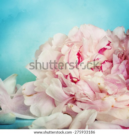 pink peony flowers with wedding ring