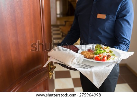 the waiter brought breakfast in the hotel room Royalty-Free Stock Photo #275964998
