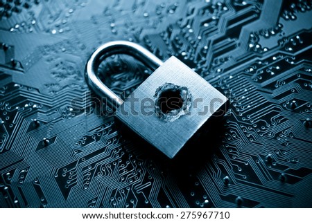 A penetrated lock security with a hole on computer circuit board background Royalty-Free Stock Photo #275967710